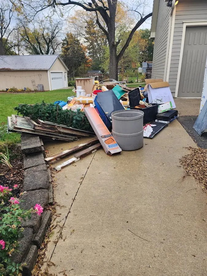 Dumpster being loaded with debris for Estate Cleanout Dumpster Rental in Banning